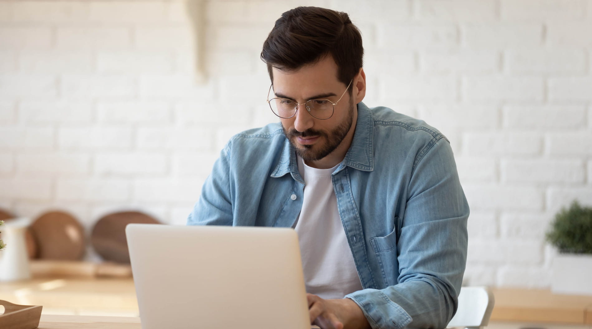 Person working on laptop at desk from home