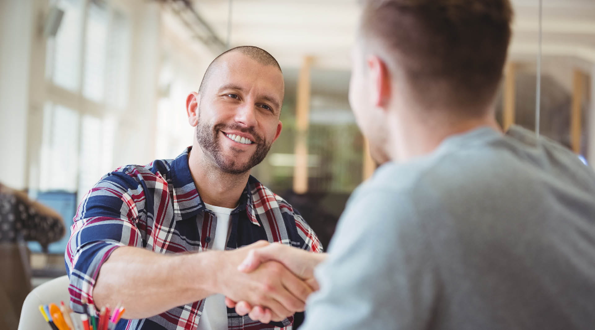 Two people shaking hands during an interview