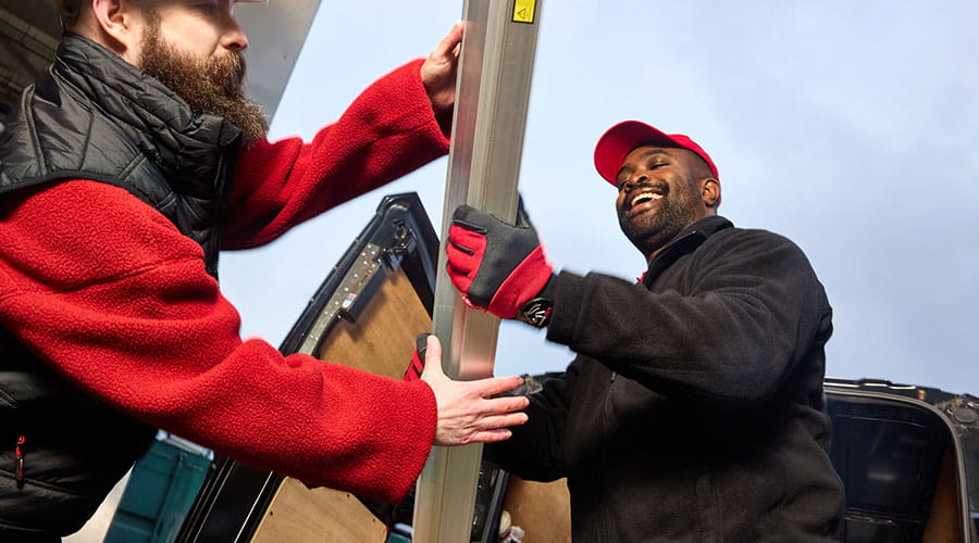 Workers greeting each other in industrial setting