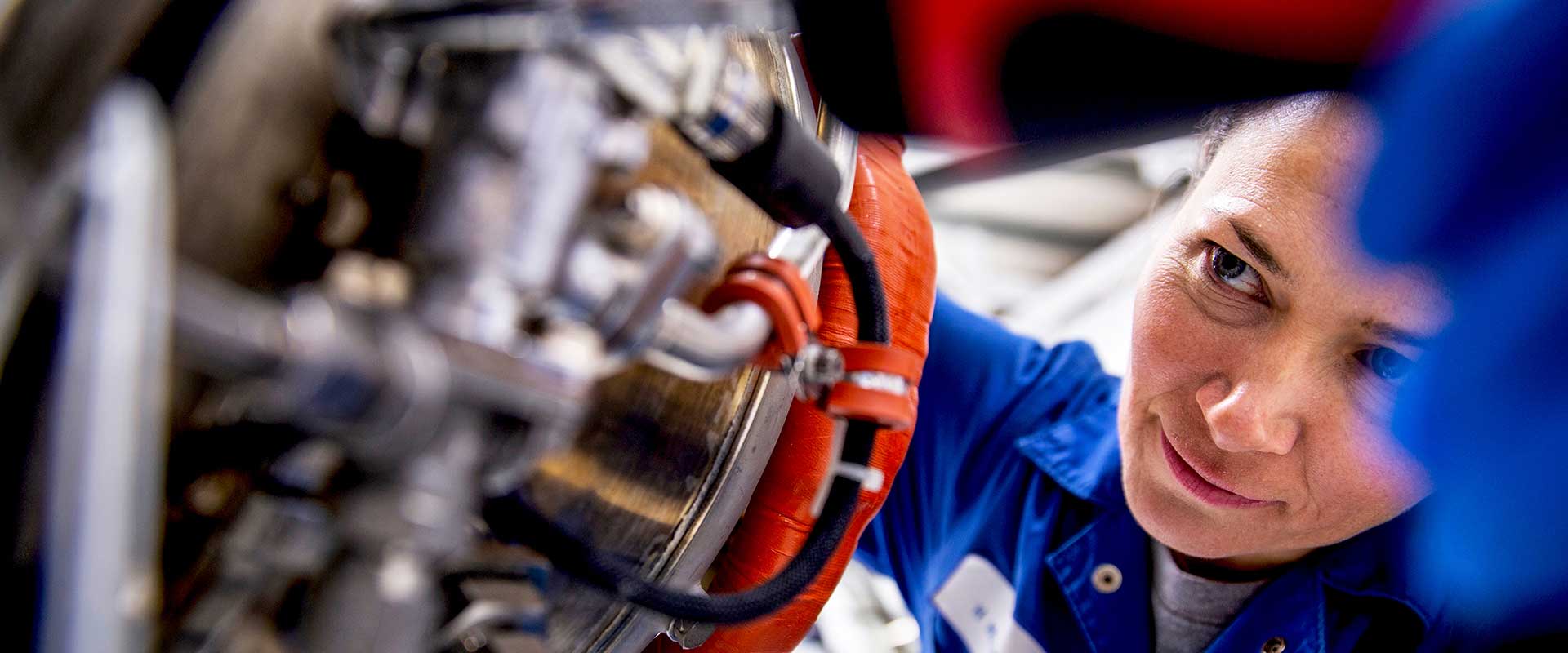 Engineer assembling mechanical parts in an industrial setting
