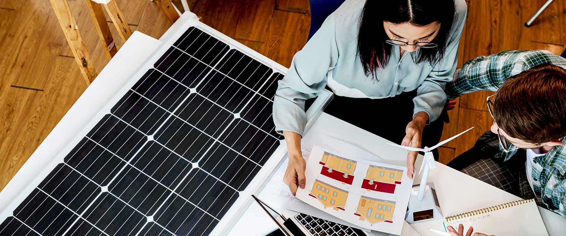 Team reviewing solar panel plans indoors