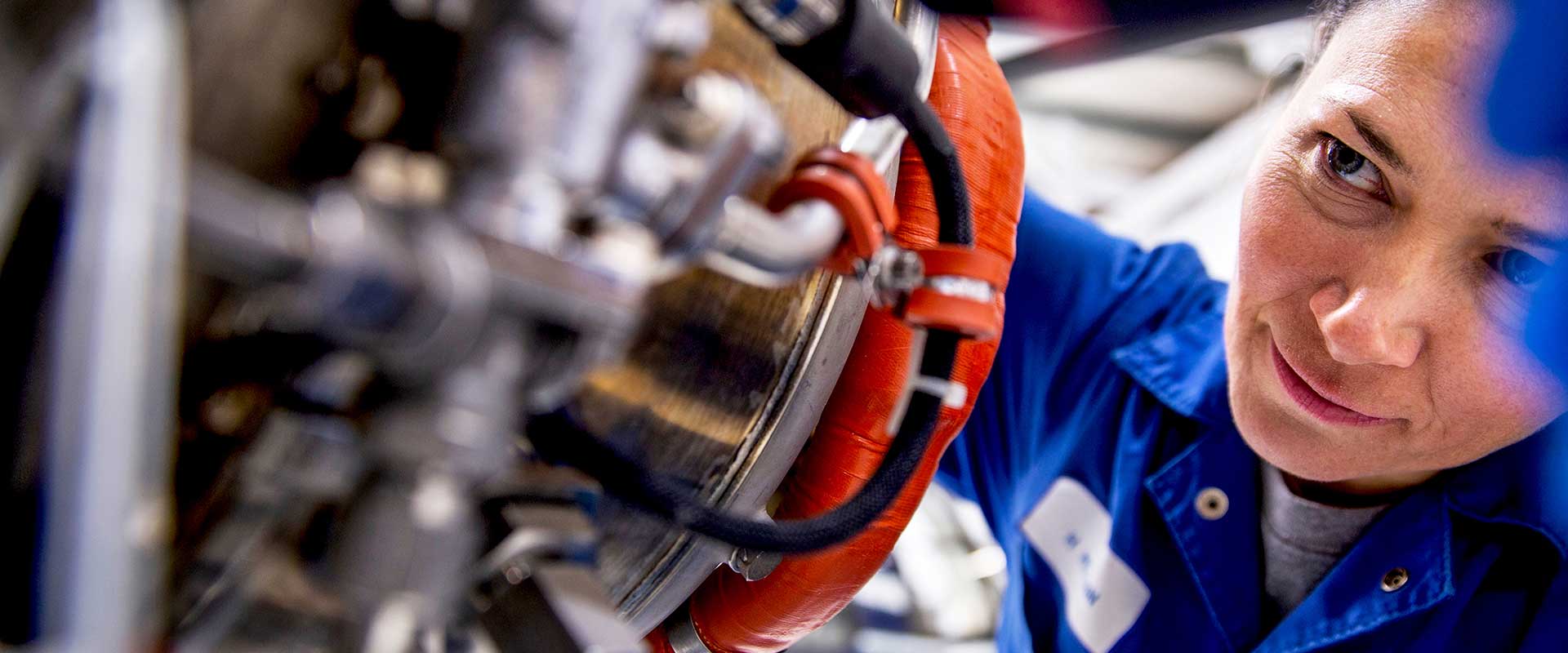 Technician inspecting machinery components in factory
