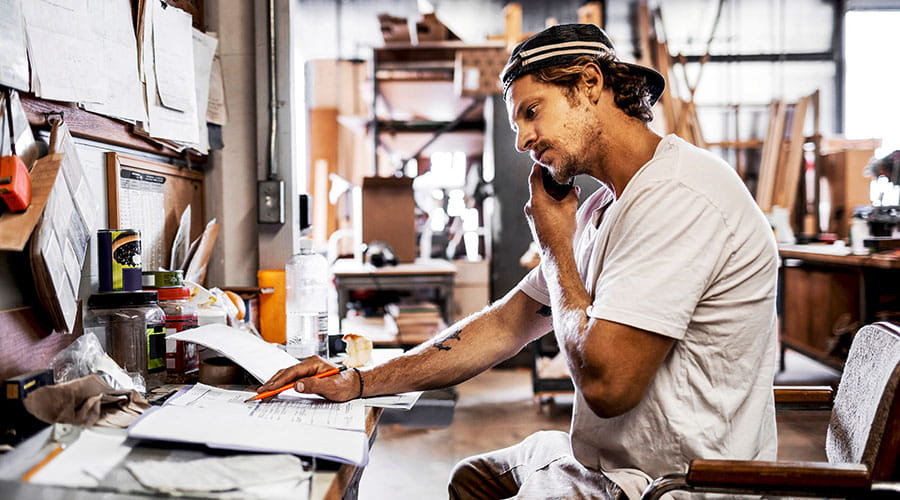 Person working at desk in workshop or studio environment