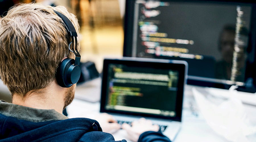 Developer working on code at computer workstation