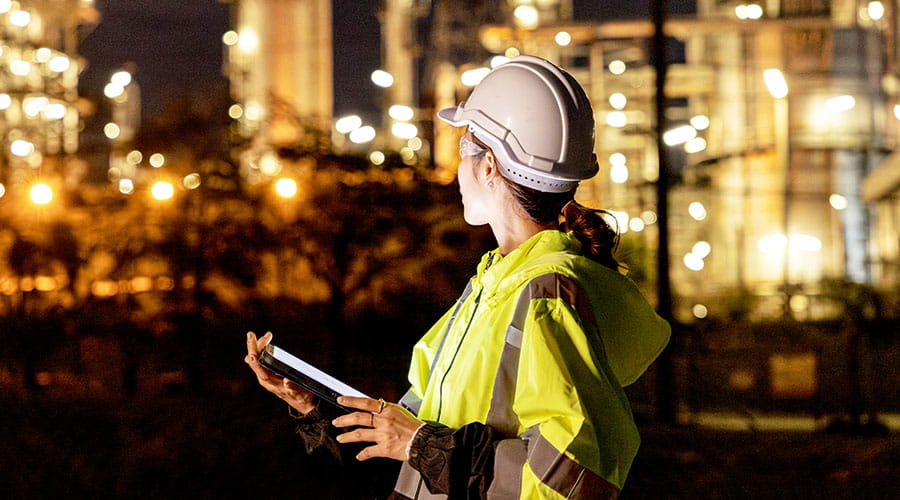 Engineer monitoring operations at industrial site
