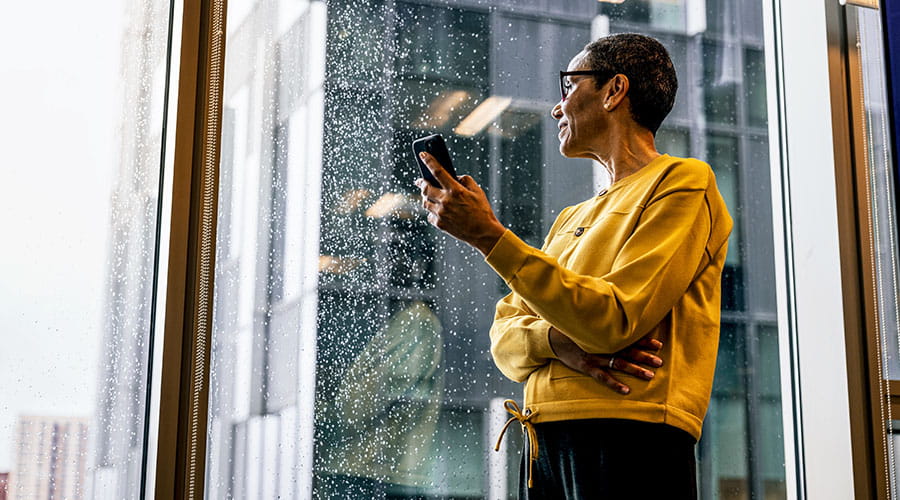 Woman using tablet near office window