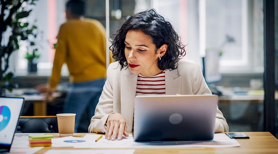 Woman working on laptop at desk