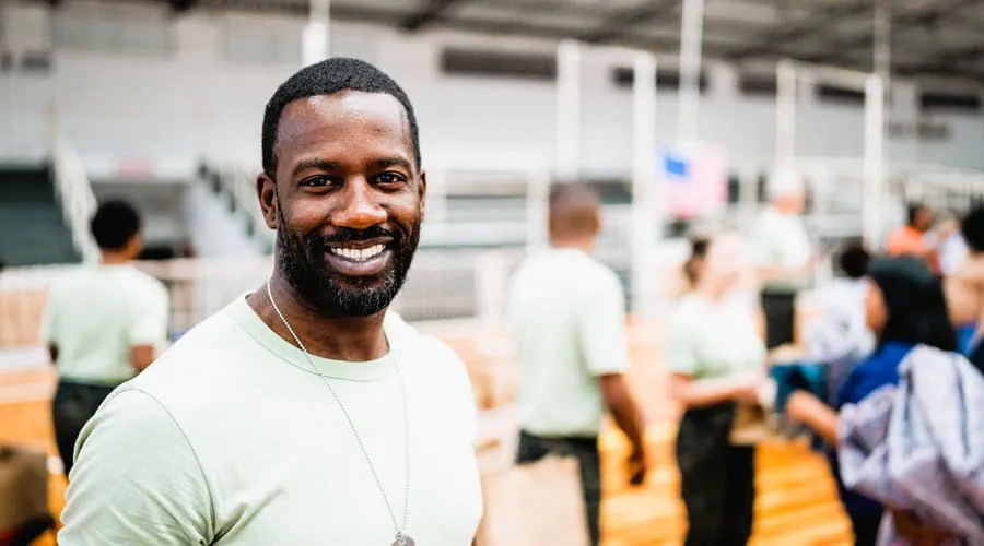 Smiling veteran standing in a busy distribution center Smiling veteran standing in a busy distribution center