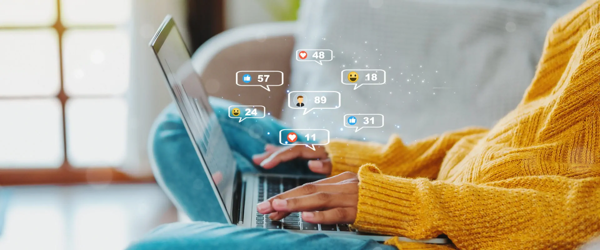 A person in a yellow sweater using a laptop with social media notification icons around the screen. A person in a yellow sweater using a laptop with social media notification icons around the screen.