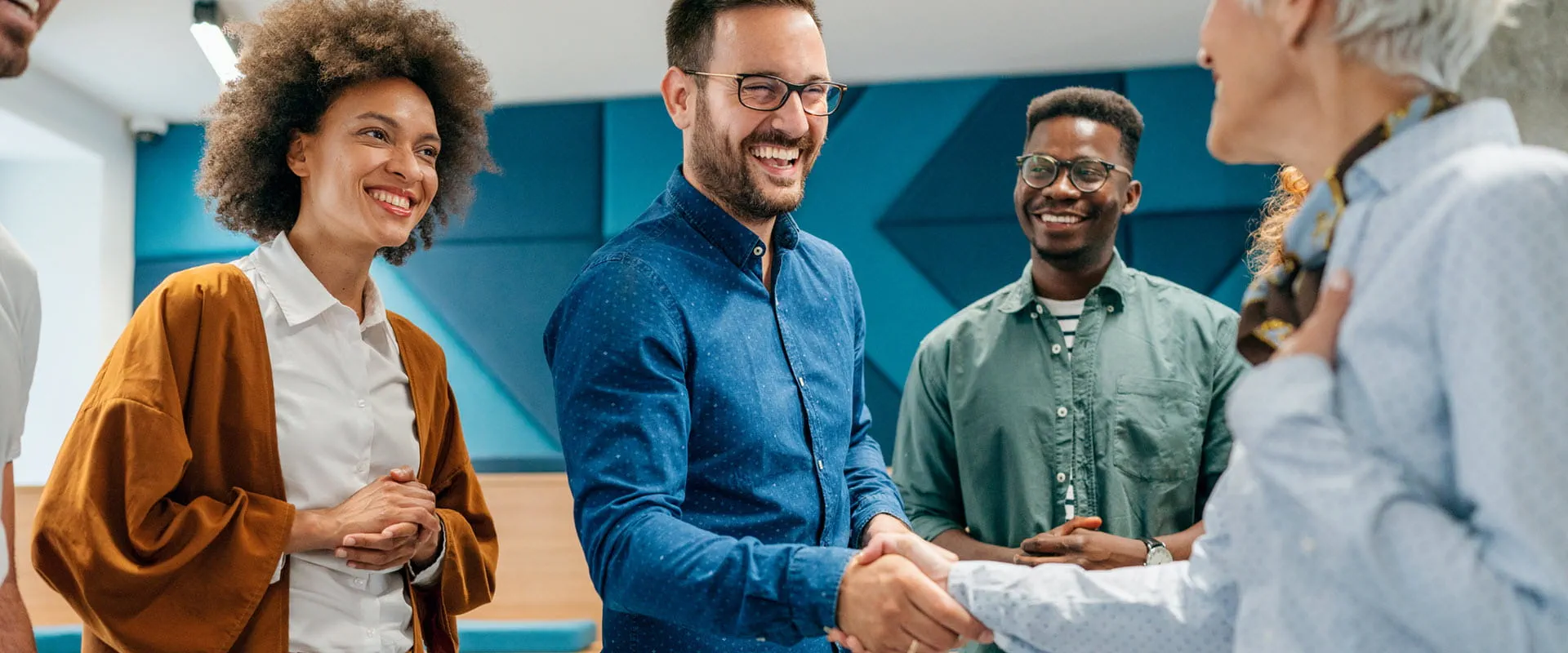 Business person shaking hands with colleague in an office. Business person shaking hands with colleague in an office.