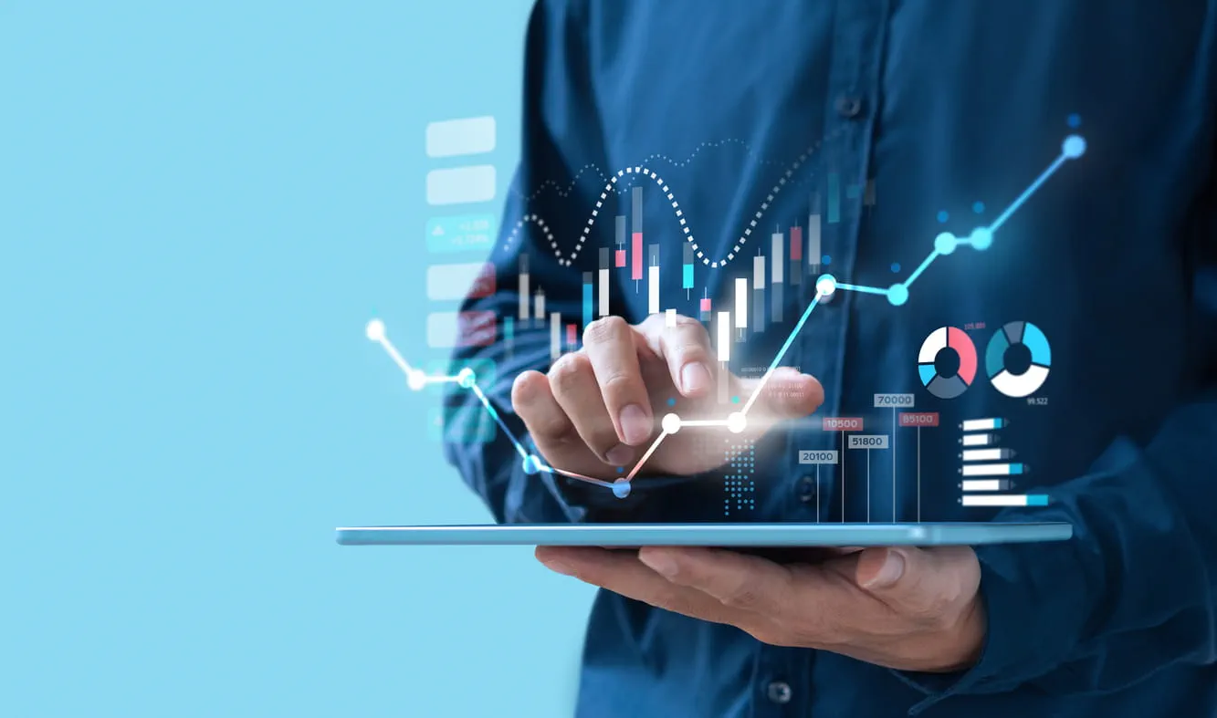 Close up of hand using tablet and graphs