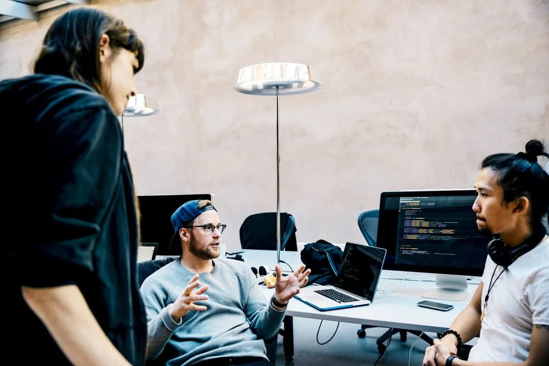 Three coworkers collaborating in an office