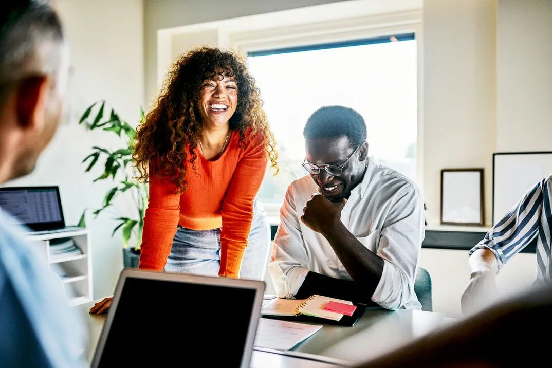 Professionals collaborating around a conference table during a team meeting, Professionals collaborating around a conference table during a team meeting,