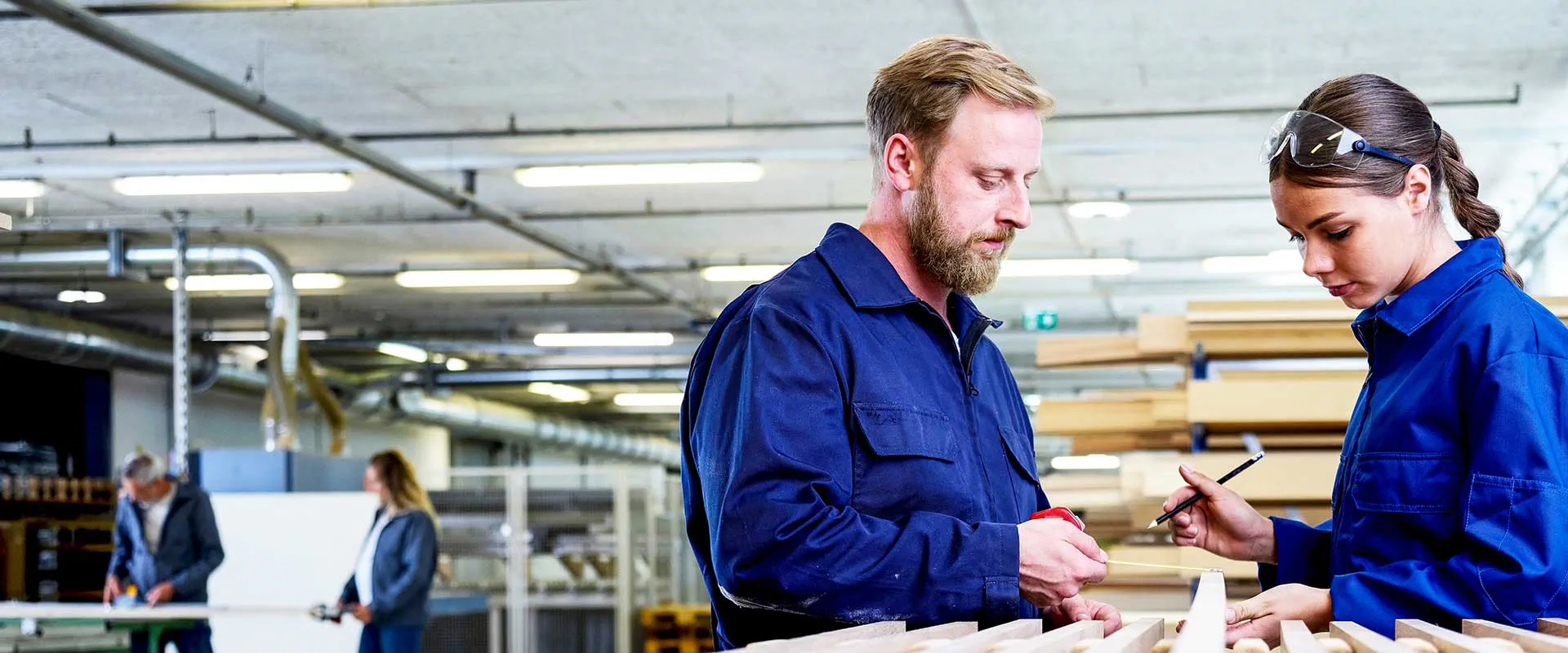  Supervisors reviewing production workflow in factory