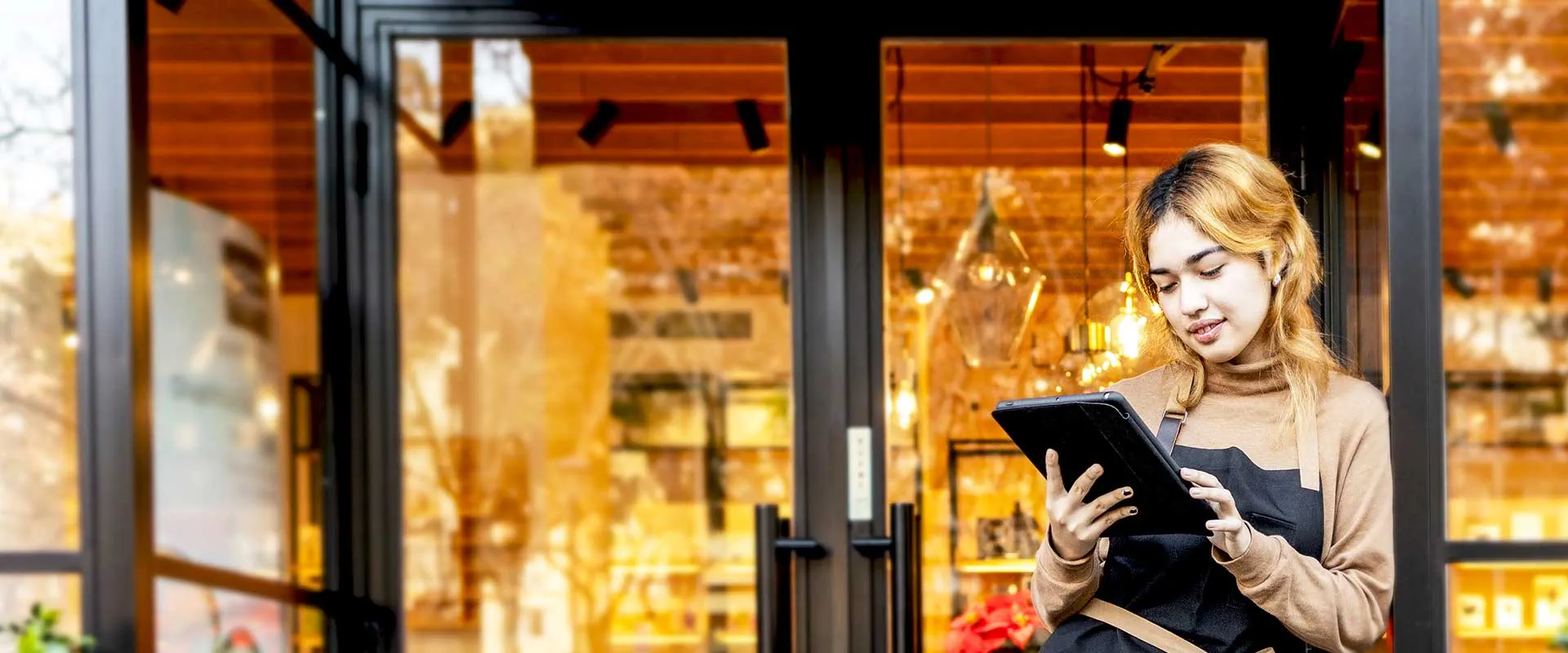  Retail worker welcoming customer at store entrance