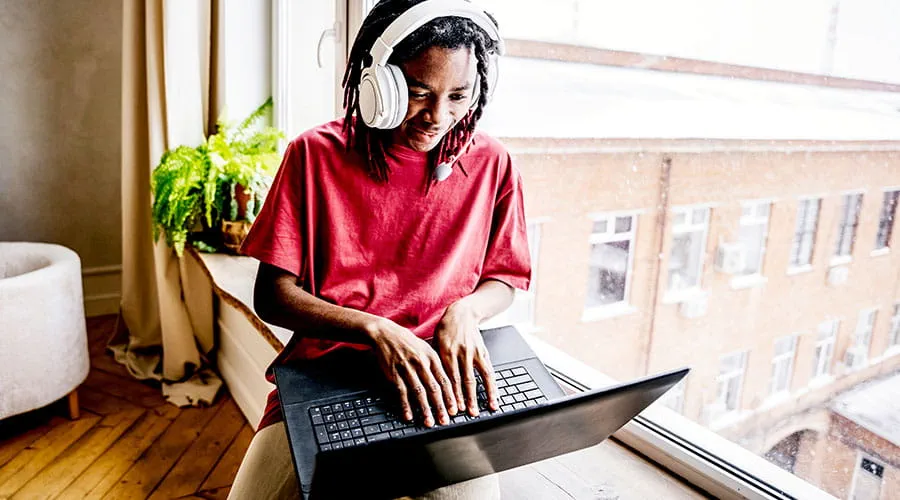  Person working remotely on laptop