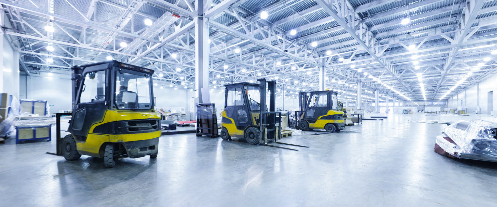 Spacious, well-lit warehouse with high ceilings and multiple forklifts. Spacious, well-lit warehouse with high ceilings and multiple forklifts.