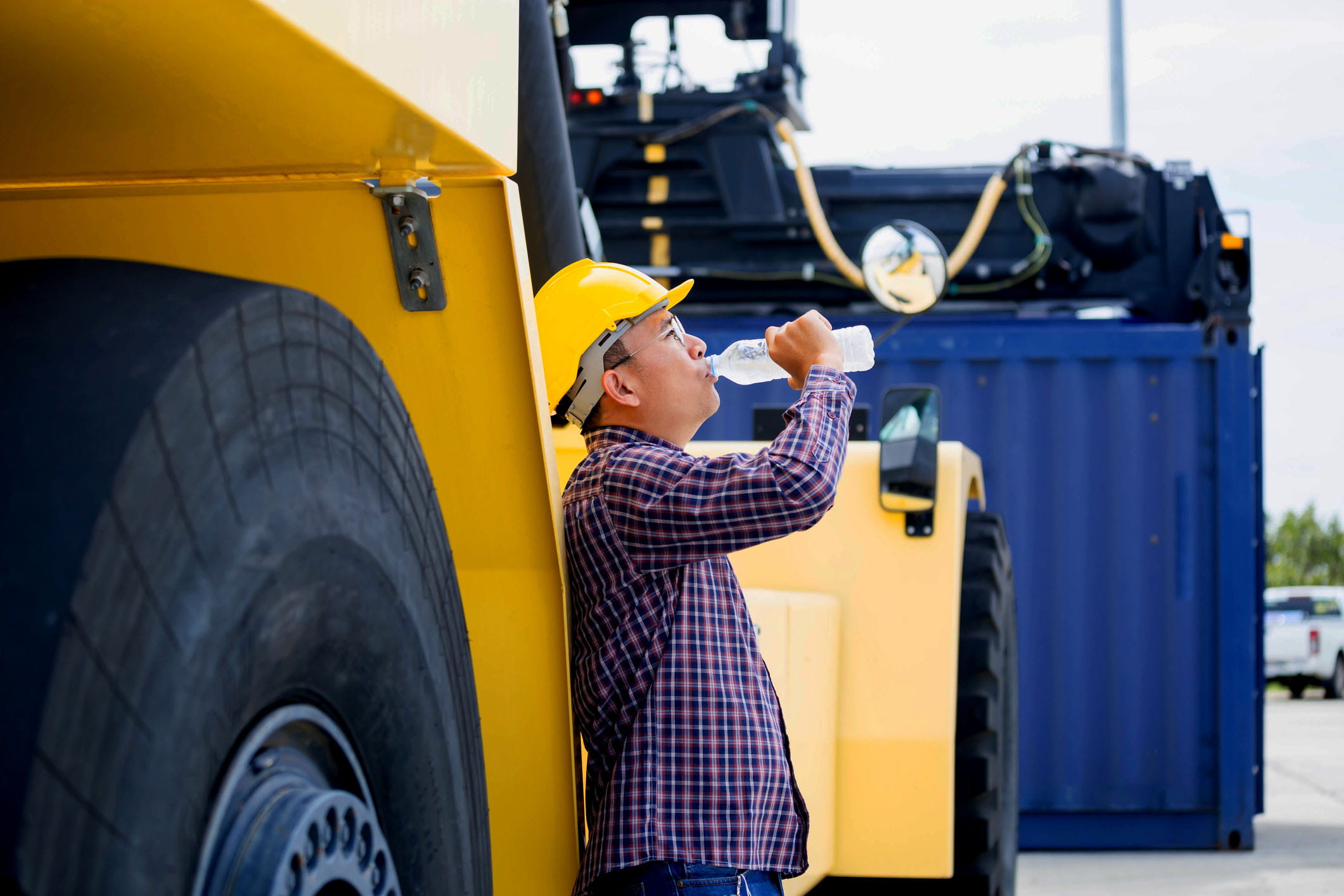 man drinking water by truck
