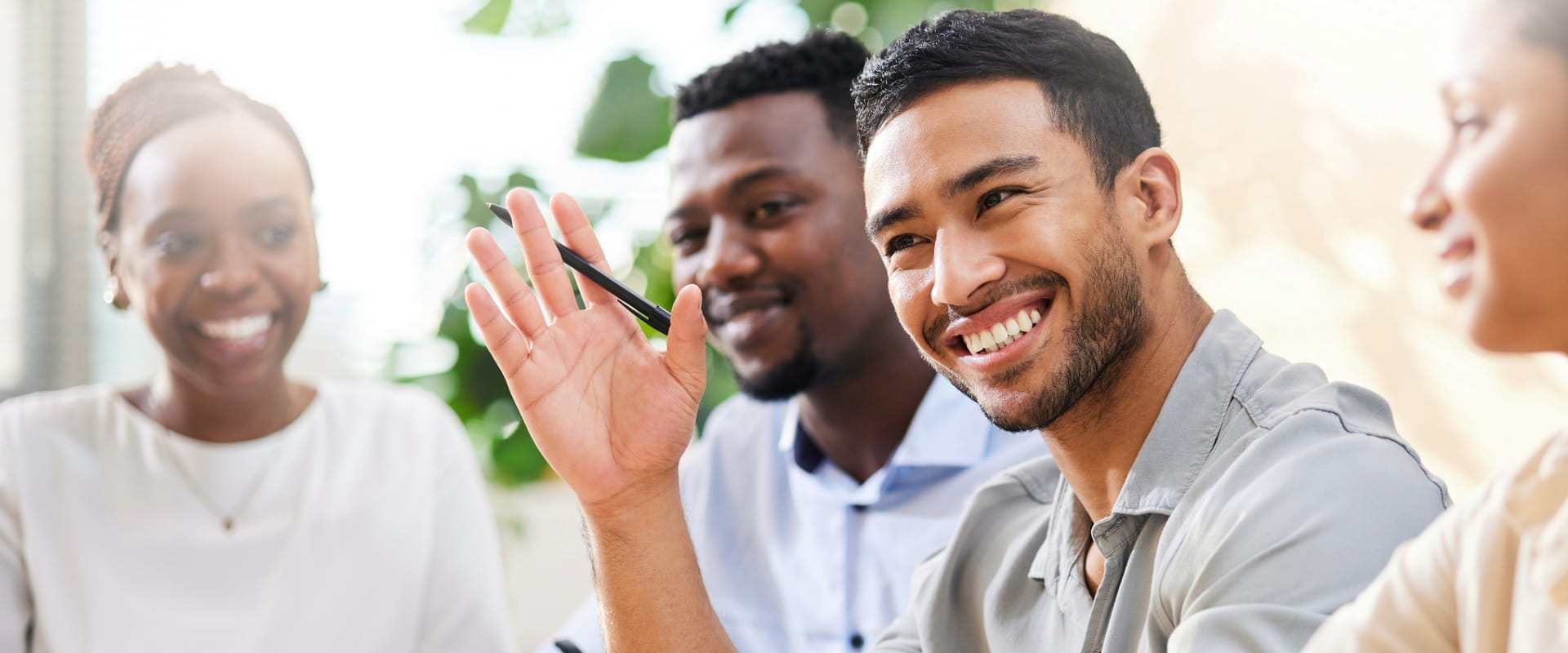 Individual raising their hand in a meeting
