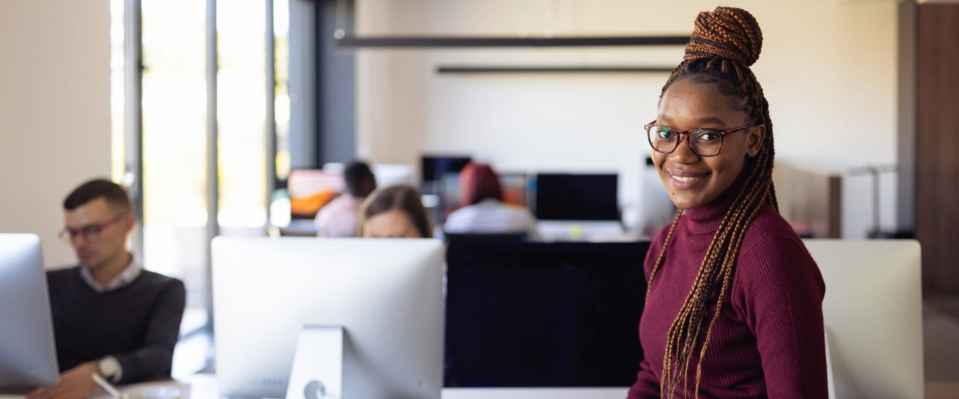 Young professional in the office, looking at the camera