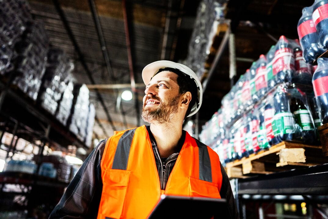 Man wearing hardhat in warehouse Man wearing hardhat in warehouse