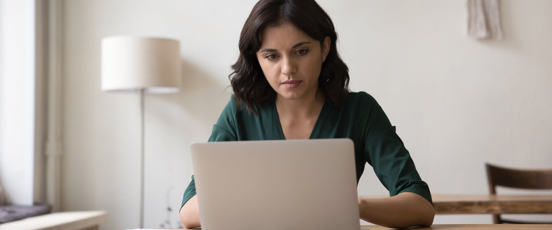 Person working on a laptop in a home office