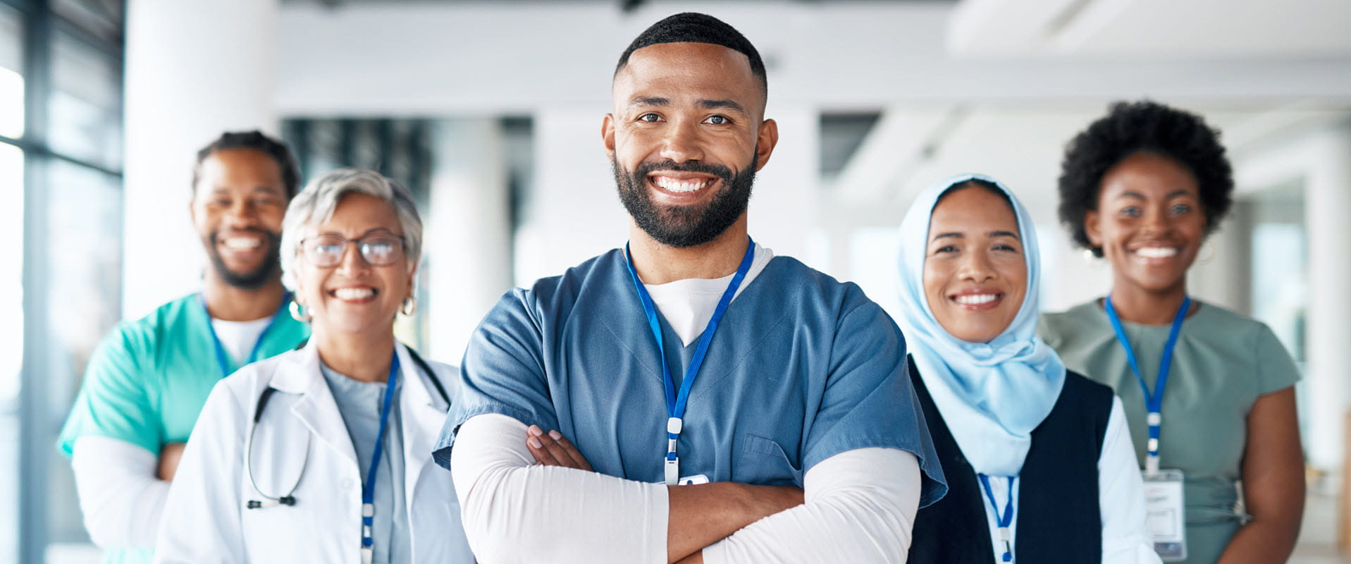 Team of medical professionals standing in hallway. Team of medical professionals standing in hallway.