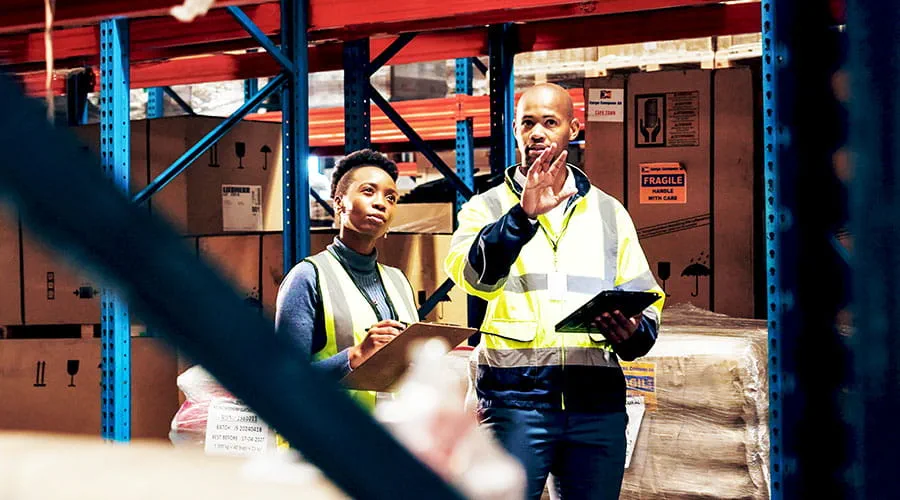 Operai discutono delle operazioni in uno stabilimento industriale Operai discutono delle operazioni in uno stabilimento industriale